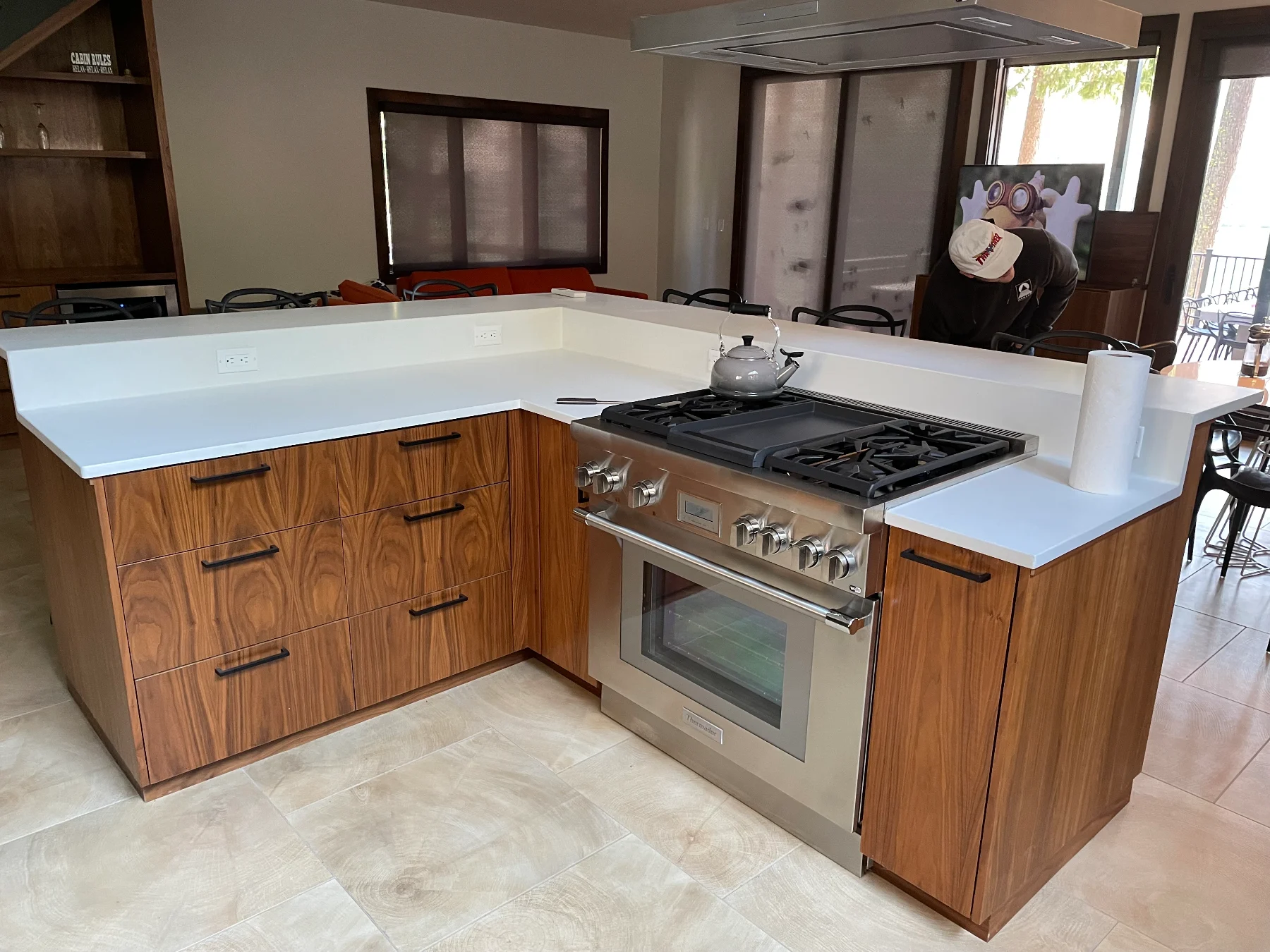 Wood-grain kitchen cabinets, white countertops and a stainless steel range
